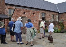 adult visitors looking round the museum playground