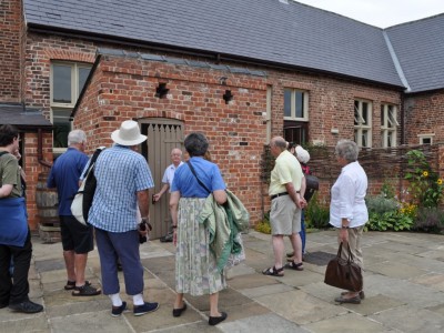 adult visitors looking round the museum playground